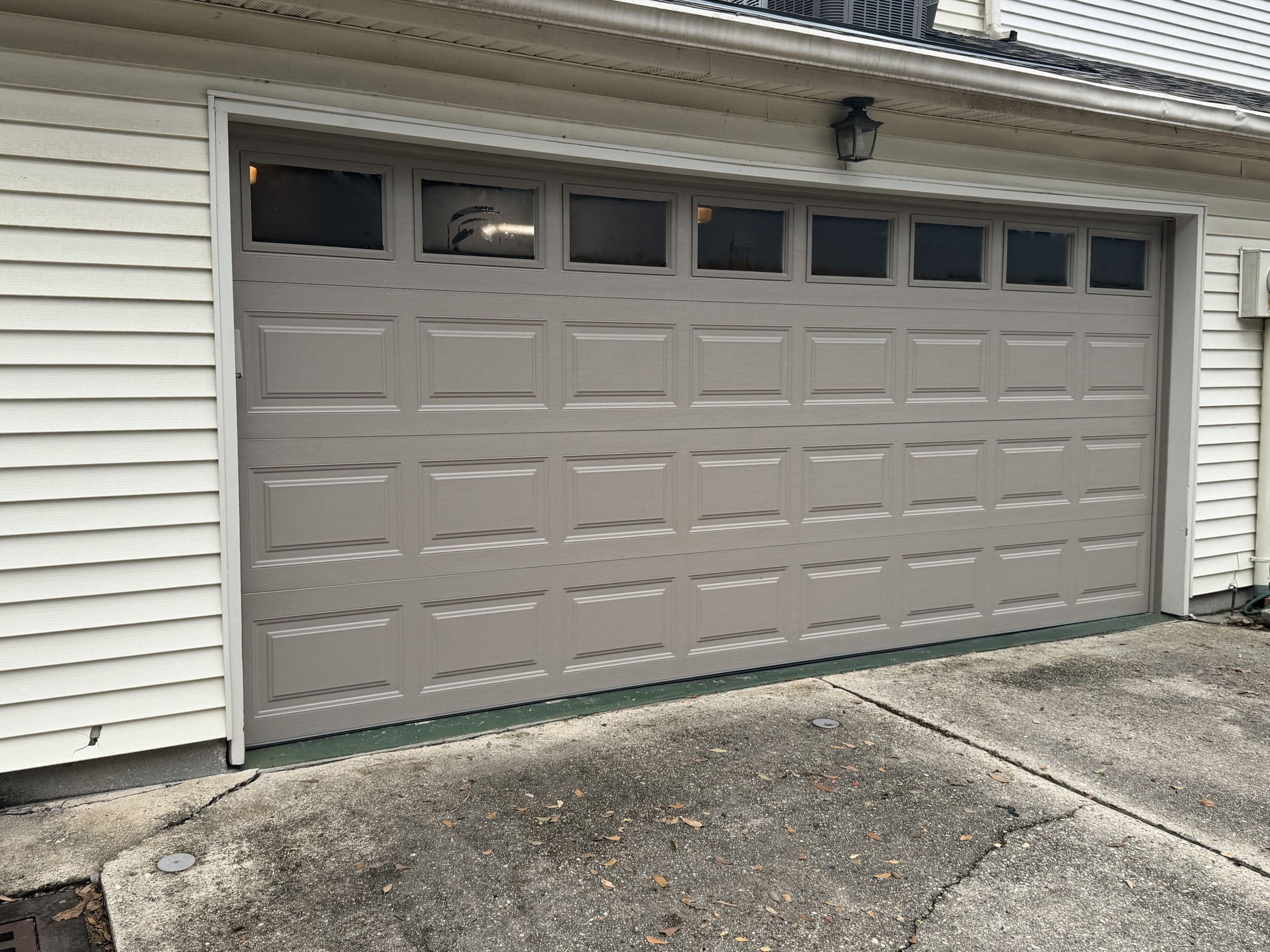 Taupe raised-panel garage door installation